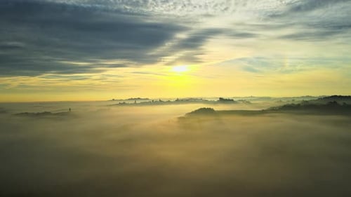 Golden Sunrise Over Foggy Valley With Rolling Hills and Skies