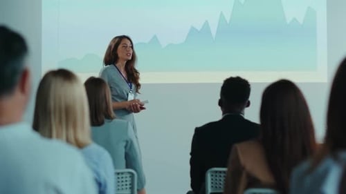 Beautiful Smart Woman Entrepreneur Making Public Speech with Presentation Screen Coaching Marketing