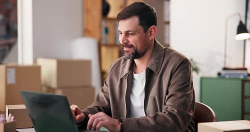 Laptop, logistics and typing with happy man in office for delivery, distribution