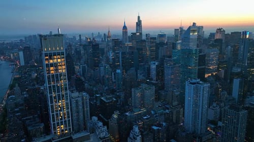 Evening time in New York city. Metropolis architecture with millions of lights