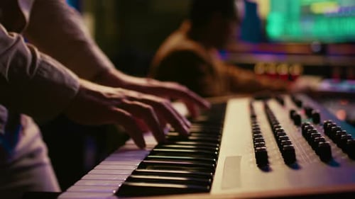 Musician Composer Playing Midi Controller Synthesizer in Professional Studio