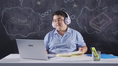 Teen Student Engaging in Online Class on Laptop