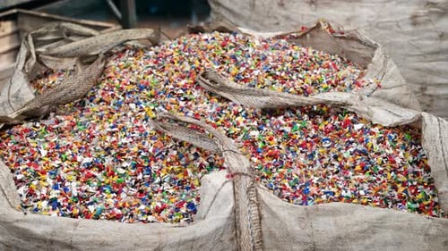 Sack of sorted multicoloured plastic garbage at waste recycling factory