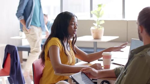 Woman Gesturing During a Meeting in the Workplace