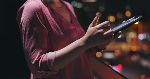 Person, hands and tablet in city at night to scroll website, reading information