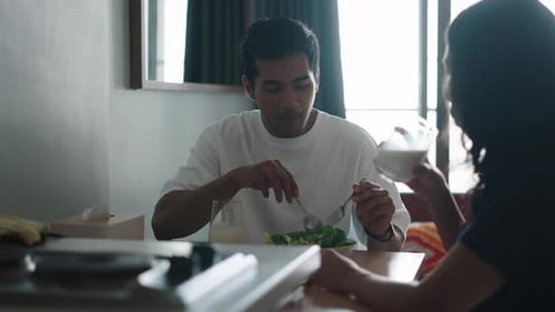 Couple Sharing Salad and Milk at Home