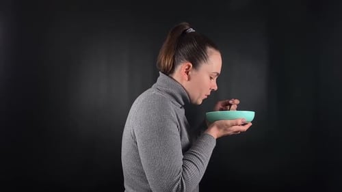 Woman Eats from a Bowl