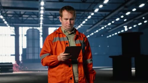 Workforce Technician Walking on Factory Floor Using Tablet Equipment