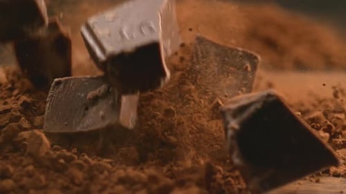 Chunks of Chocolate Falling Into Powdered Chocolate with High Speed Camera