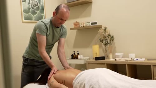 Man Massaging Woman's Back at Home Spa