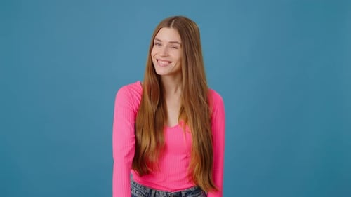 Woman Gives Thumbs Up on Blue Background
