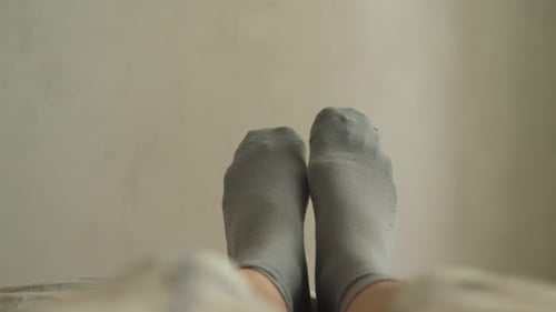 Feet Wearing Socks Relaxing in Bedroom