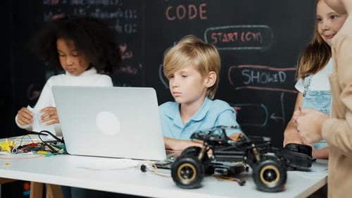 Boy using laptop programing engineering code and writing program. Erudition.