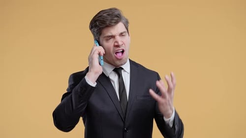 Angry Man Yelling on Phone in Business Suit