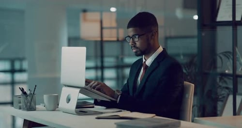 Man Working Late on Laptop in Modern Office
