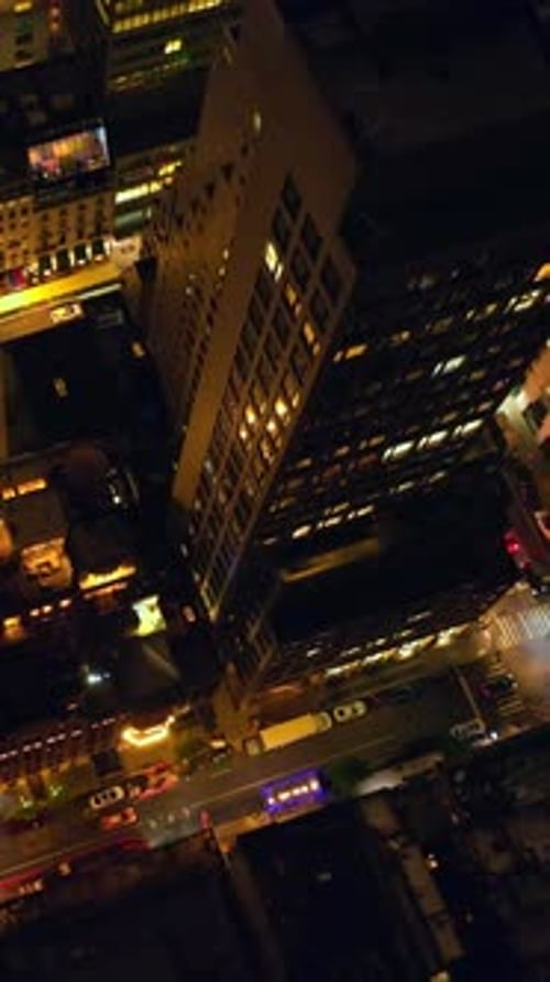 Vibrant New York at night time. Drone footage descending over the streets full of cars