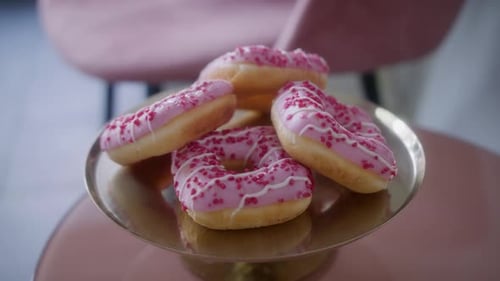 Donuts on Gold Stand with Pink Frosting and Sprinkles