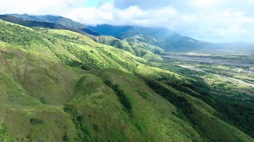 Fly over green grass mountain in the Philippines