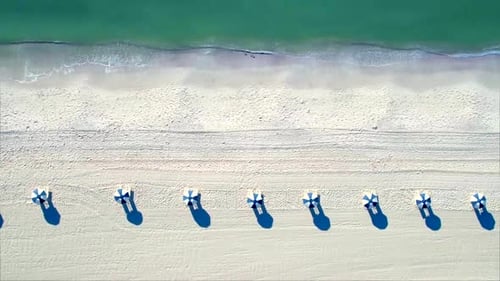 Aerial drone view of colorful umbrellas on naples Florida beach in summer