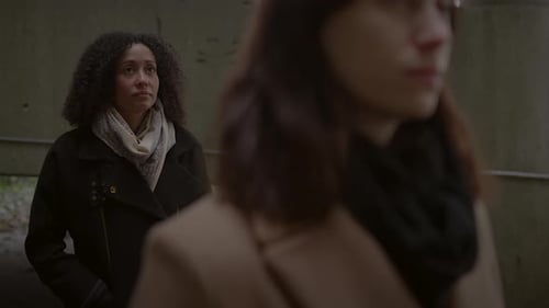 Lifestyle Portrait of Two Young Women Watching Tower Building Together