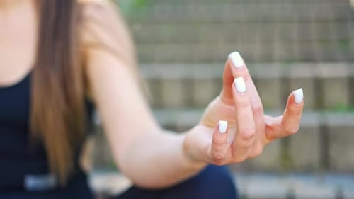 Woman Meditating Outdoors With Hand in Mudra