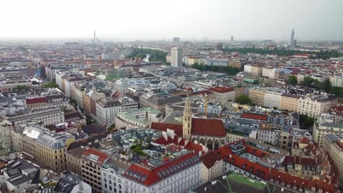 Aerial view showcases a vibrant Vienna cityscape blending historic and modern buildings. Push Forwar