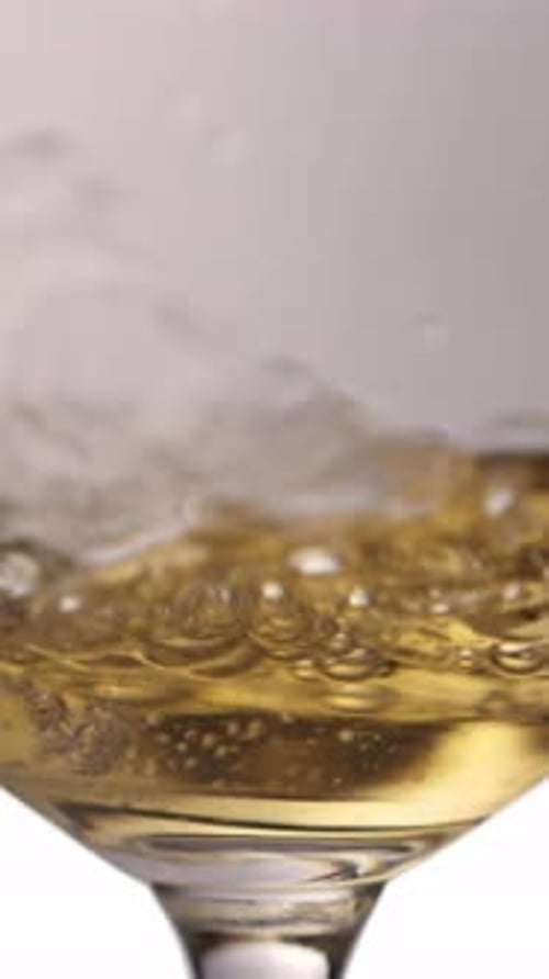 Pouring White Wine Into Glass Slow Motion Vertical