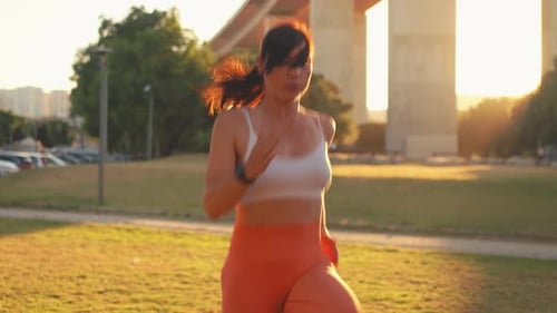 Determined Jogger Woman Exercising at City Park During Sunny Day