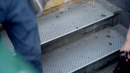 NYC subway steps people walking during summer in flip flops