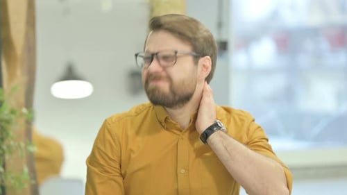 Man Experiencing Neck Pain in Office