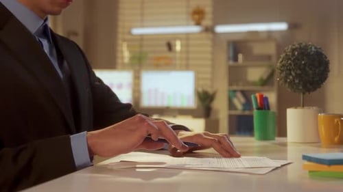 Side View of a Young Man is Looking Through and Then Signing a Contract