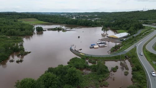 Highway roads flooded diverting traffic after river floodwater submerges streets and fields