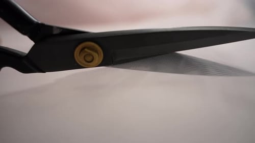 Sharp Scissors Cutting White Mesh Fabric, Close Up