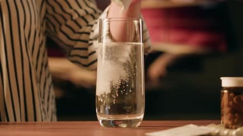 Powder Being Poured into Water for Health