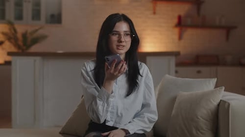 Young Woman Using Voice Assistant at Home
