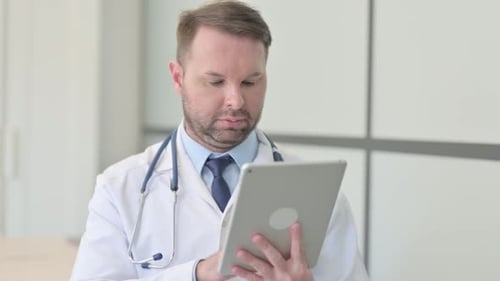 Doctor Using Tablet Device in Hospital Setting