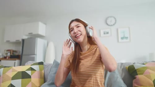 Enthusiastic Woman Dancing With Headphones at Home