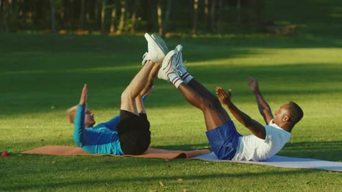 Two Men Doing Sit-Ups in the Park