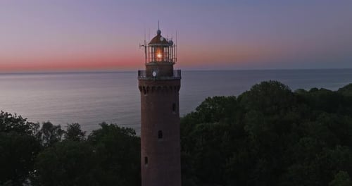 Aerial view of tall lighthouse with light beam, Baltic Sea
