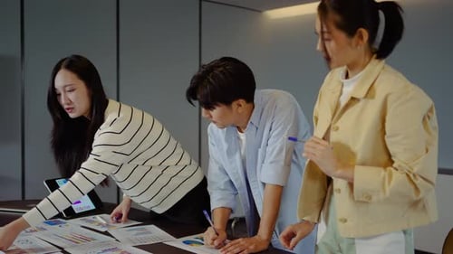 Team Discussing Business Charts at Office Table