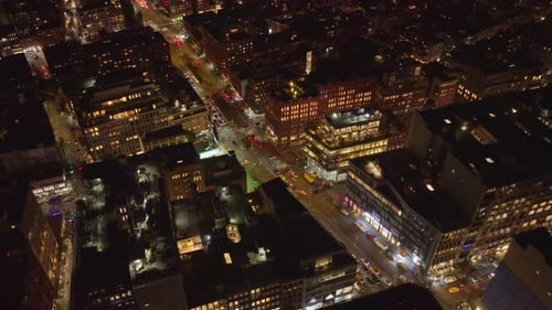 Aerial Nighttime Cityscape Showcasing Bustling Manhattan Streets Illuminated Roadways Filled with