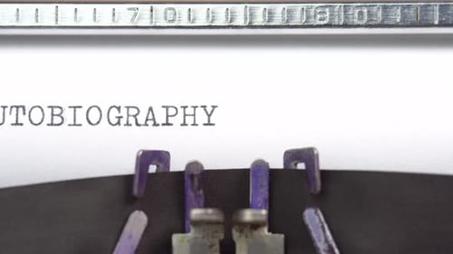 Autobiography word closeup being typing and centered on a sheet of paper on old vintage typewriter