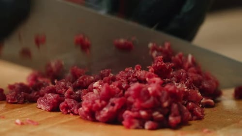 Close Up of Chopping Raw Red Meat