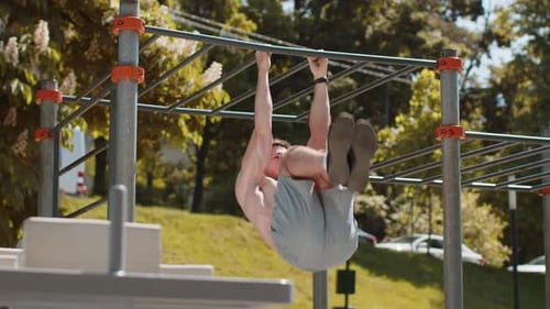 Man Working Out on Bar in Outdoor Gym