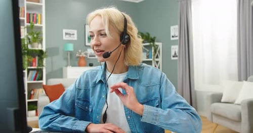 Woman with Headset Working at Computer