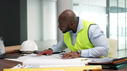 Busy professional and creative design architect engineer, drawing on building planning blueprints