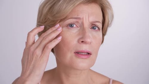 Woman Examining Face, Looking at Wrinkles