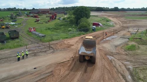 Dump Truck Driving Through Construction Site Aerial Shot