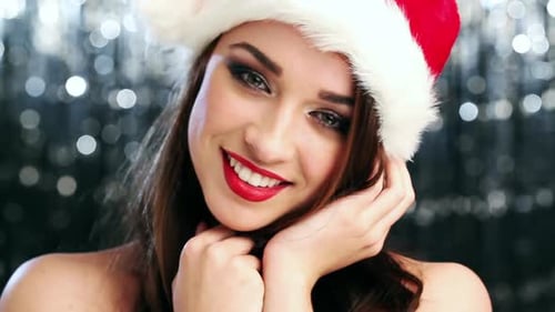 4k video footage of a young woman in a christmas hat against a studio background