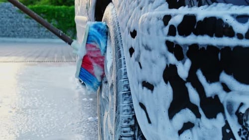 Washing Luxury Black Car on Touchless Car Wash Cleaning the Details of Car Washing Sedan Car with